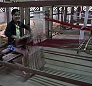 Girl weaving in a textile village around Luang Prabang
